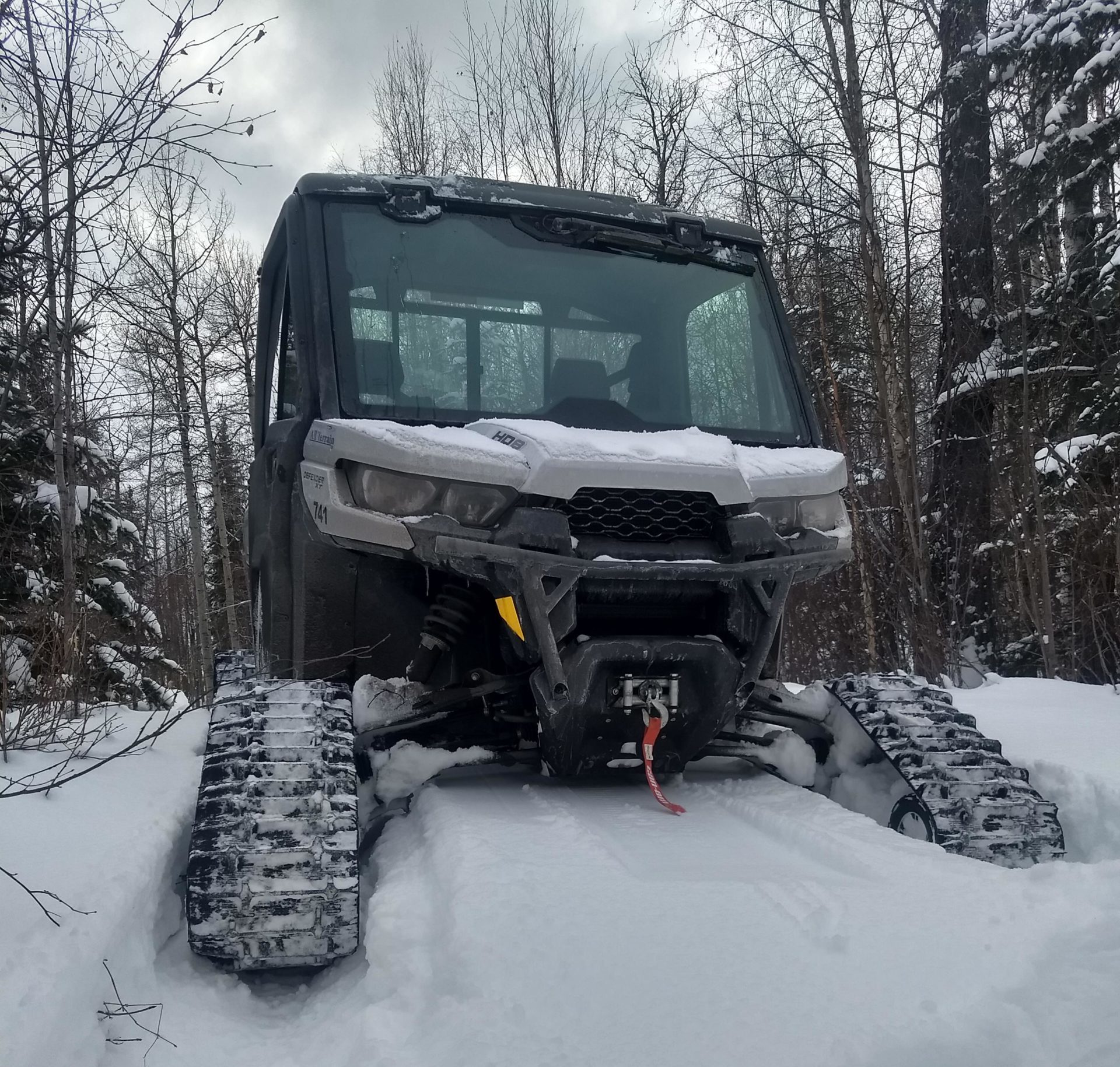 Can-Am Defender with enclosed heated cab and tracks